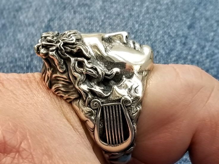 Handmade Apollo ring in sterling silver 925. The Greek God is handcrafted in high quality silver to ensure durability and a lifetime value.  A harp/ lyre is depicted on either side of this statement ring. Apollo was the mythological Greek God of light, music and dance.  The symbolic ring is definitely a piece of jewelry that will be complimented. The Apollo ring is delivered in a gift box. Free worldwide shipping with DHL or Fedex. Please message a mobile phone number for delivery purposes. All Greek God Of Light, God Of Light, God Apollo, Family Rings, Greek God, Silver Signet Ring, Valentines Gifts For Him, Statement Ring Silver, Light Music