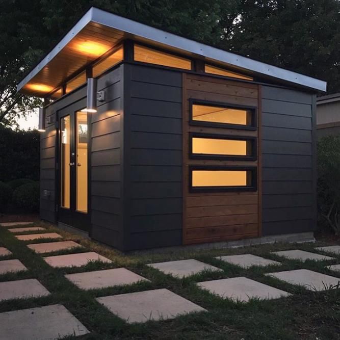 a small house with lights on the windows