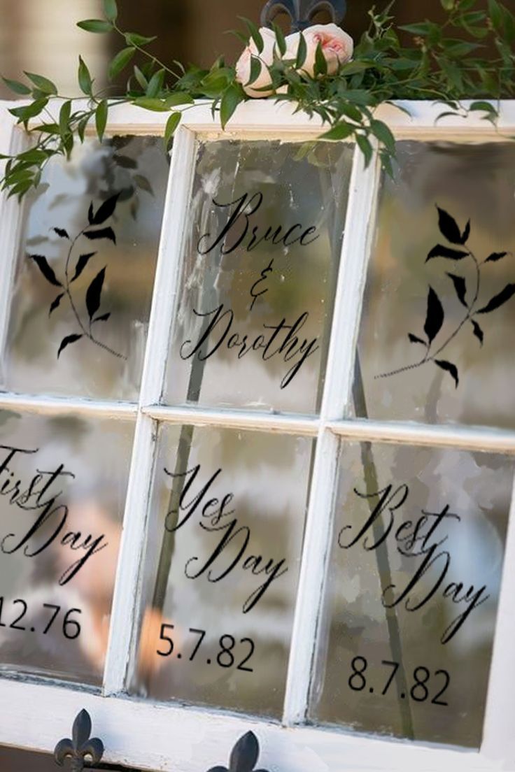 four glass windows with names and flowers on them