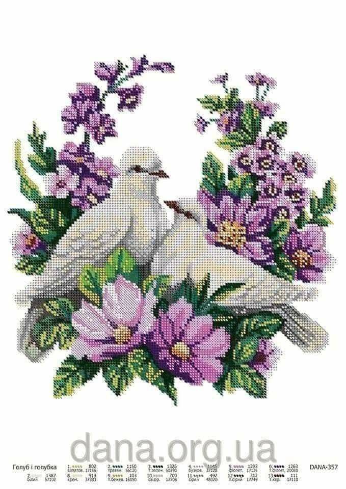 two white birds sitting on top of purple flowers