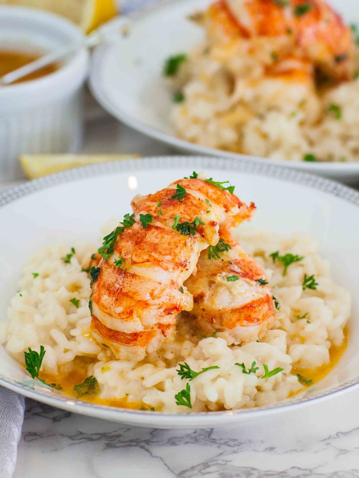 two white plates topped with shrimp and rice