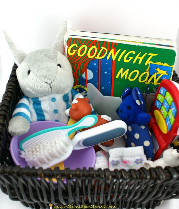 a basket filled with toys sitting next to a book