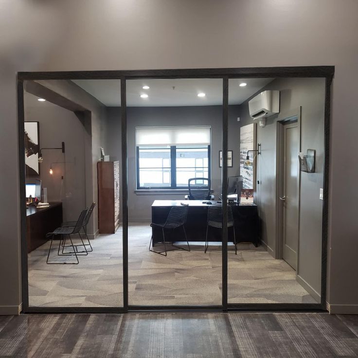 an empty room with sliding glass doors leading into the kitchen