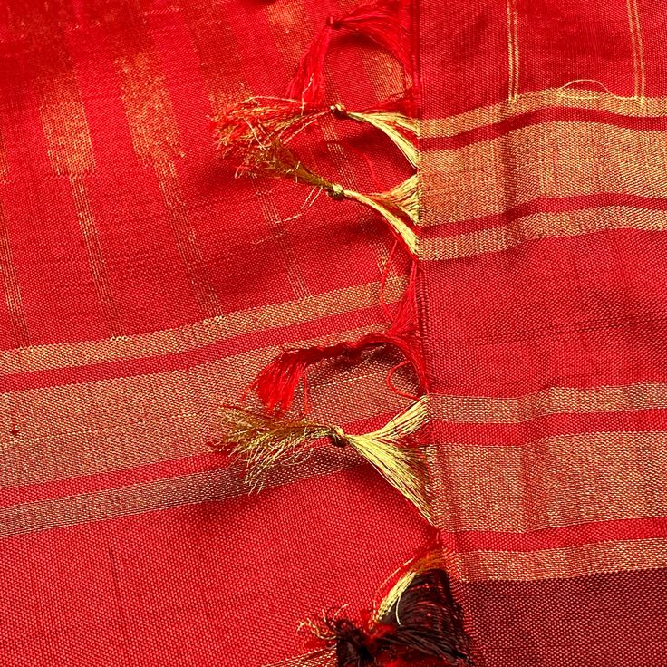 This elegant chevron pattern pochampally silk saree in purple shot with red is handwoven. The rettai pett tissue golden zari borders in red color is pleasing. The pallu is mirrors the borders in gold zari woven in seepu rekku pattern. Approximate Length 6.5 mtrs (inclusive of blouse length)Height - 46 - 50” Saree comes with fall, picot and tassels done when applicable. Blouse piece is cut. Approximate weight - 600 gms Kindly Note : The colors you see on your device may vary due to the color reproduction, brightness and resolution of individual devices. If you'd like more clarity before your purchase, please contact our support team. ***The model has partially draped the saree on the pallu portion to show the color, feel and flow of the saree.*** Red Bollywood Style Dupatta In Slub Silk, Red Bollywood Slub Silk Dupatta, Red Bollywood Dupatta In Slub Silk, Red Traditional Wear In Slub Silk With Cutdana, Bollywood Style Red Dupatta In Slub Silk, Festive Red Slub Silk Dupatta, Traditional Red Slub Silk Pre-draped Saree, Red Slub Silk Dupatta For Diwali, Red Tussar Silk Pre-draped Saree For Festivals