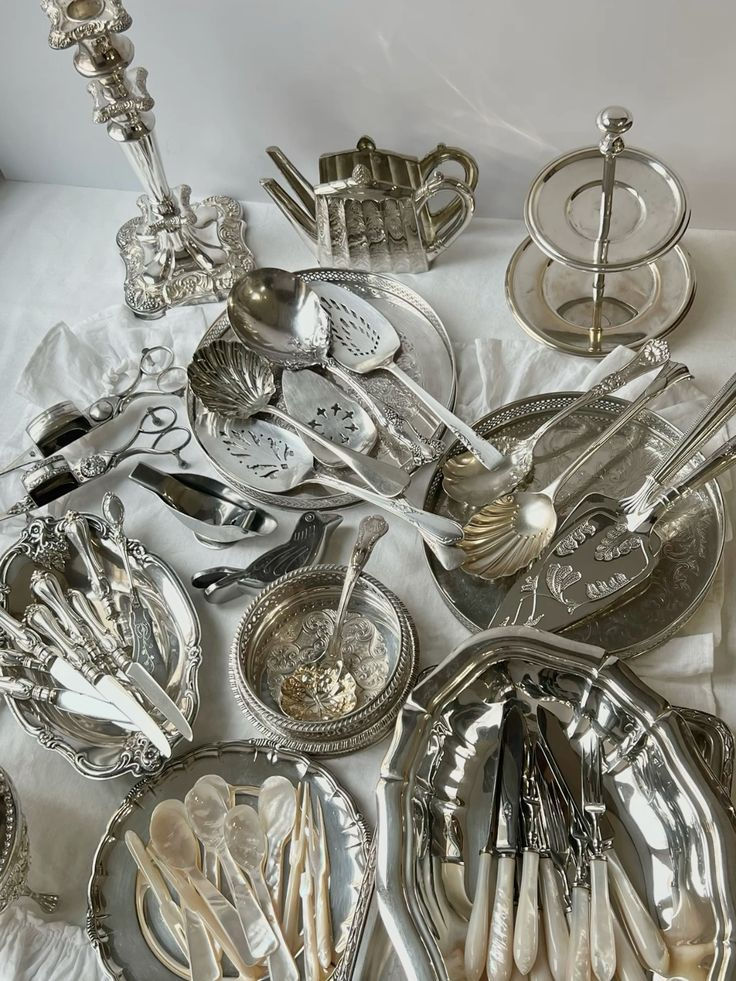 a pile of silverware sitting on top of a bed