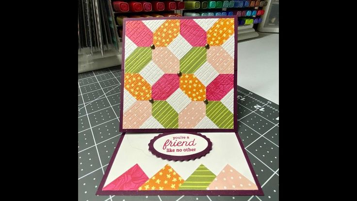 a close up of a card on a table with some crafting supplies in the background