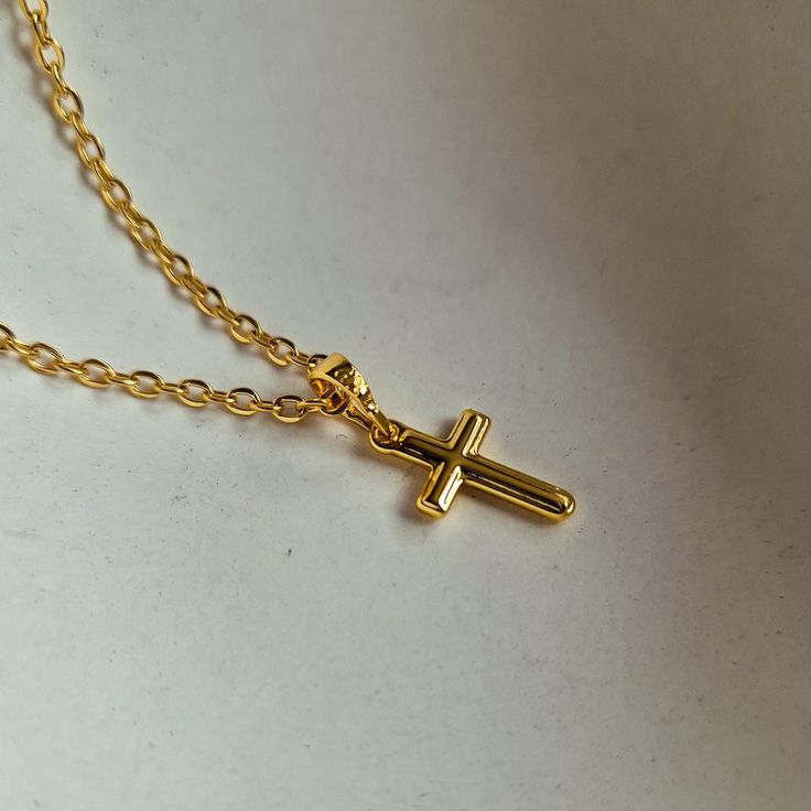 Cute and minimals cross crucifix pendant necklace for everyday. Pro tip: Layer it with one or two other chains. - Pendant size: 1.6cm x 0.9cm - 45cm / 18" stainless steel chain included - Pendant material: Copper - 18K Gold Plated Dainty Crucifix Cross Necklace With Delicate Chain, Dainty Cross Necklace For Everyday, Minimalist Cross Charm Necklace With Delicate Chain, Minimalist Crucifix Cross Necklace With Delicate Chain, Everyday Cross Charm Necklace With Adjustable Chain, Minimalist Cross Necklace With Delicate Chain Crucifix, Everyday Minimalist Cross Pendant Necklace, Minimalist Daily Wear Cross Pendant Necklace, Minimalist Everyday Cross Necklace