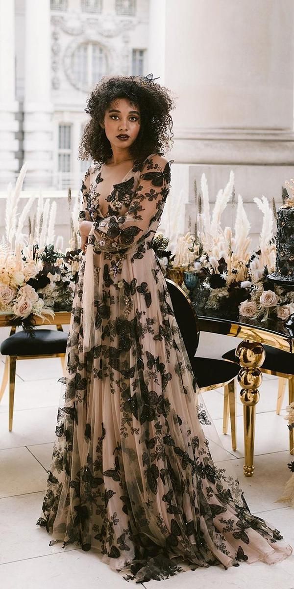 a woman standing in front of a table with flowers