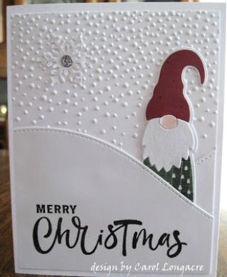 a merry christmas card with a santa hat and beard on the front, sitting on top of a wooden table