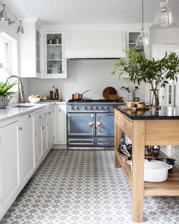 a kitchen filled with lots of white and blue appliances