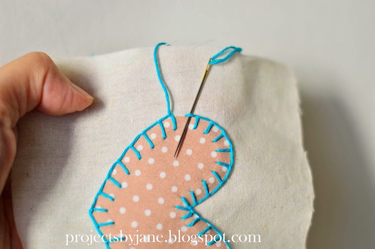 someone is stitching something on to a piece of fabric