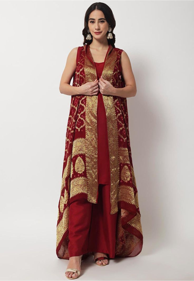 Readymade Art Silk Straight Kurta in Maroon This Sleeveless and Round Neck attire with cotton Lining is Woven Ornamental Motifs Available with a Art Silk Palazzo in Maroon and Faux Georgette Jacquard Shrug in Maroon Do Note: Accessories shown in the image are for presentation purposes only and length may vary upto 2 inches.(Slight variation in actual color vs. image is possible). 1 inch is equal to 2.54 centimeters. Luxury Red Kurta For Festivals, Luxury Cotton Silk Set With Zari Weaving, Luxury Slub Silk Set With Zari Weaving, Brocade Suits, Silk Cape, Embroidered Kurti, A Line Kurta, Silk Bottoms, Silk Suit