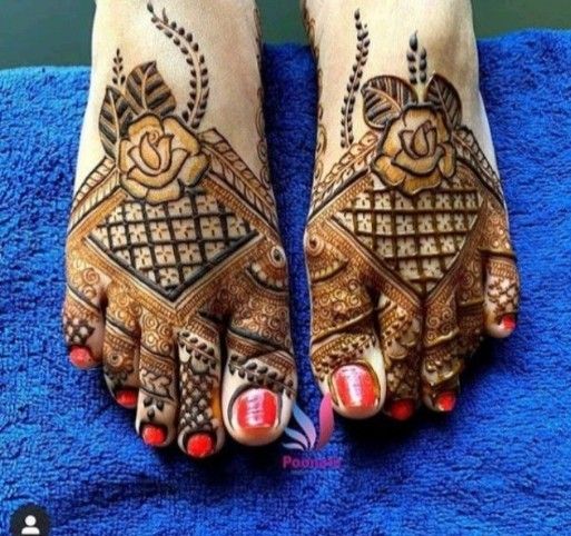 two feet with henna tattoos on them