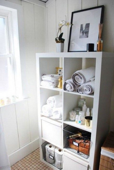 a bathroom with towels and other items on the shelves