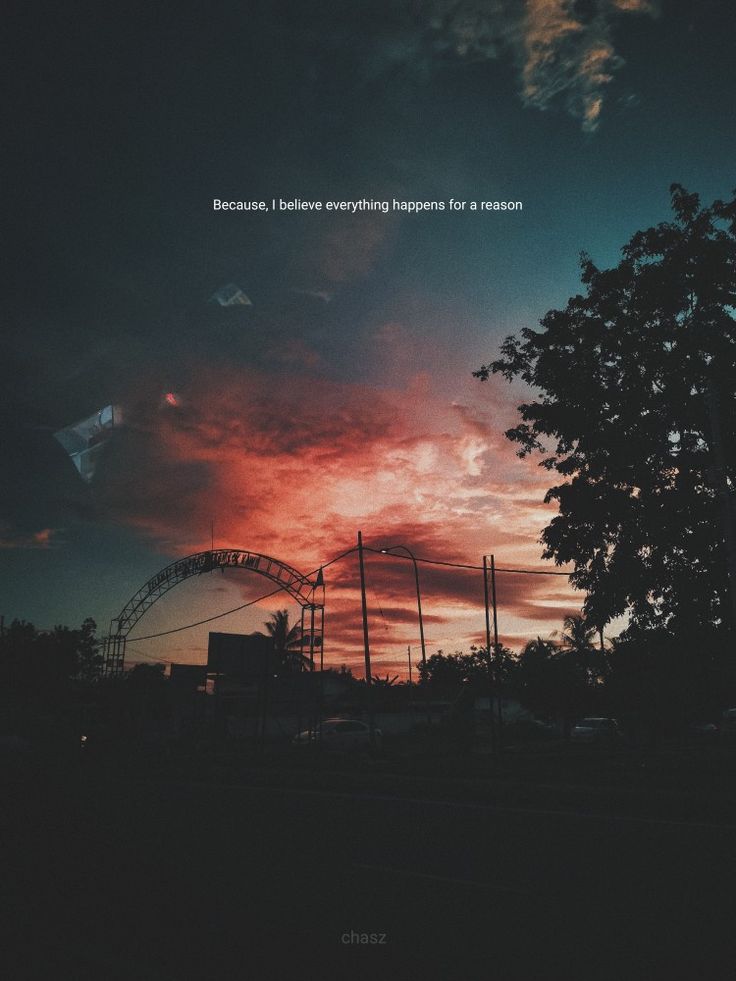 the sun is setting behind a ferris wheel and some trees in front of it with an inspirational quote