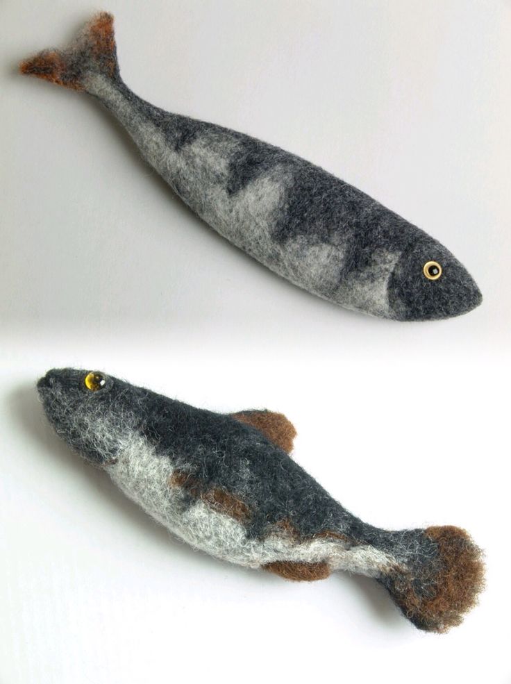 two fish made out of felt sitting next to each other