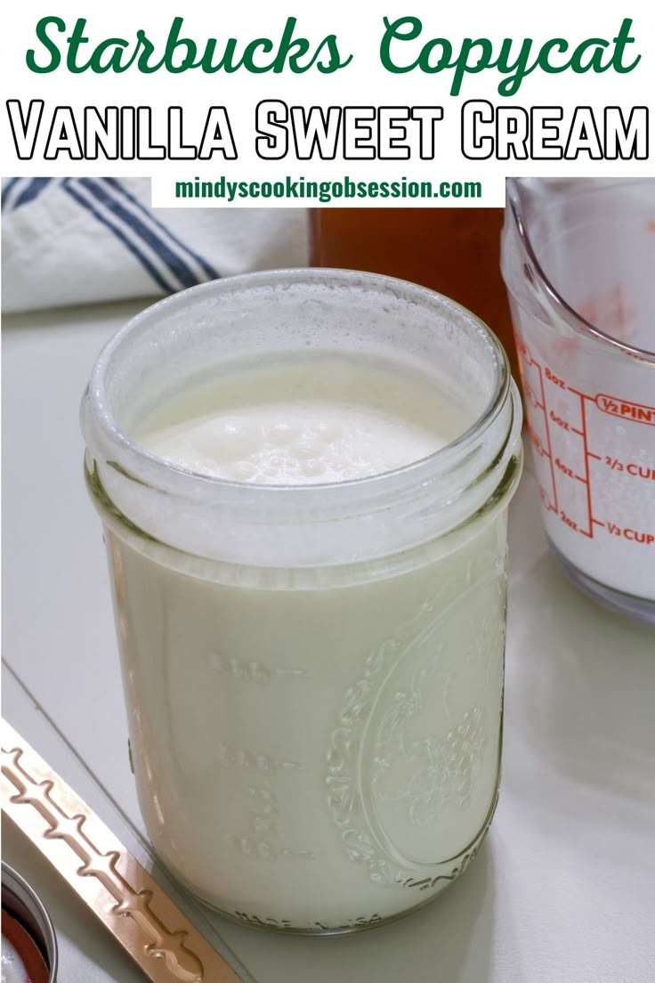 a jar of vanilla sweet cream sitting on top of a table next to a spoon