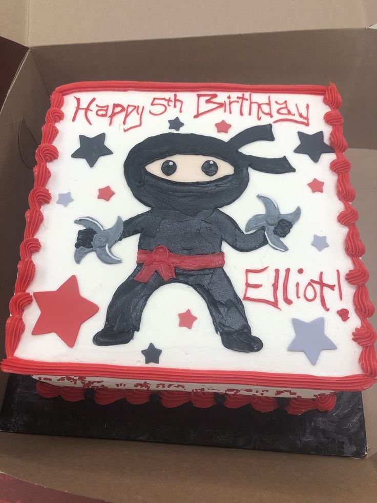 a birthday cake in the shape of a ninja with stars on it and an embellished name