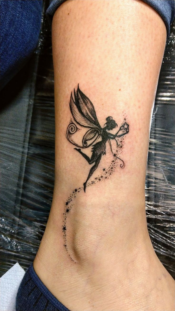 a woman's foot with a small tattoo on the side of her leg and a fairy