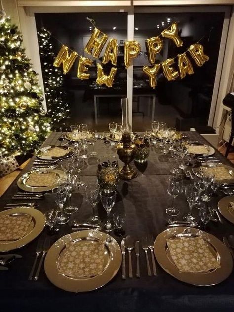 a table set up for a new year's eve celebration with plates and silverware