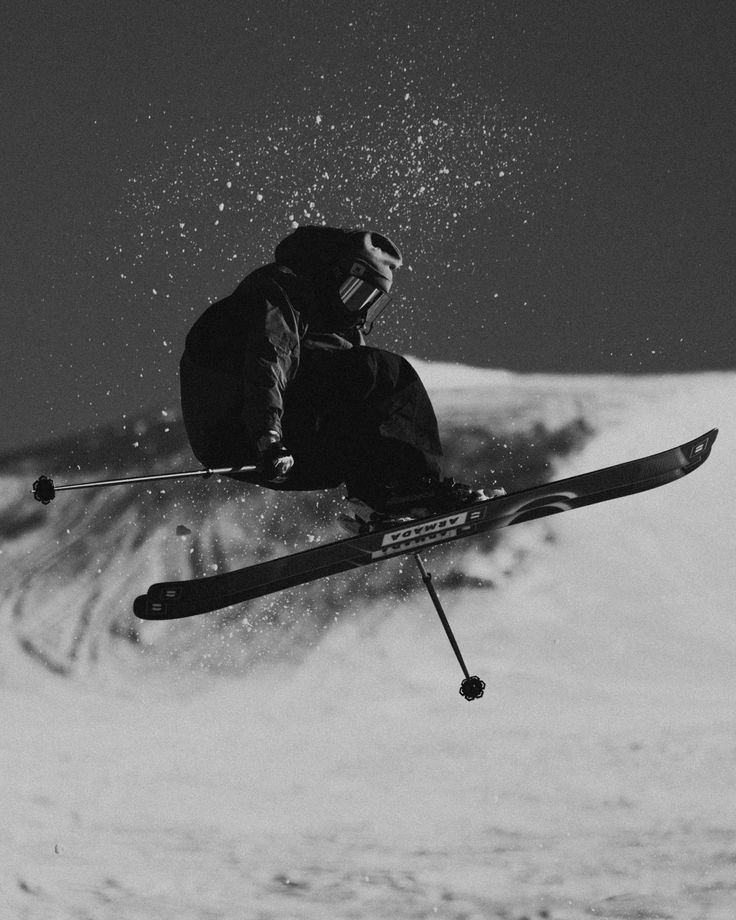 a man flying through the air while riding skis