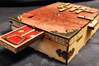 an old wooden box sitting on top of a bed