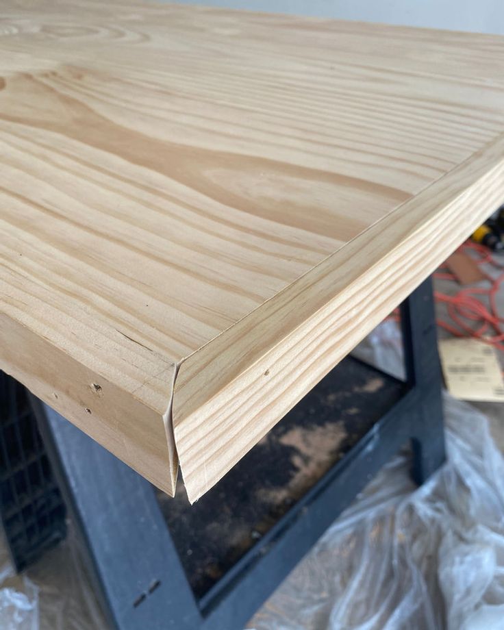 a wooden table being constructed with plywood