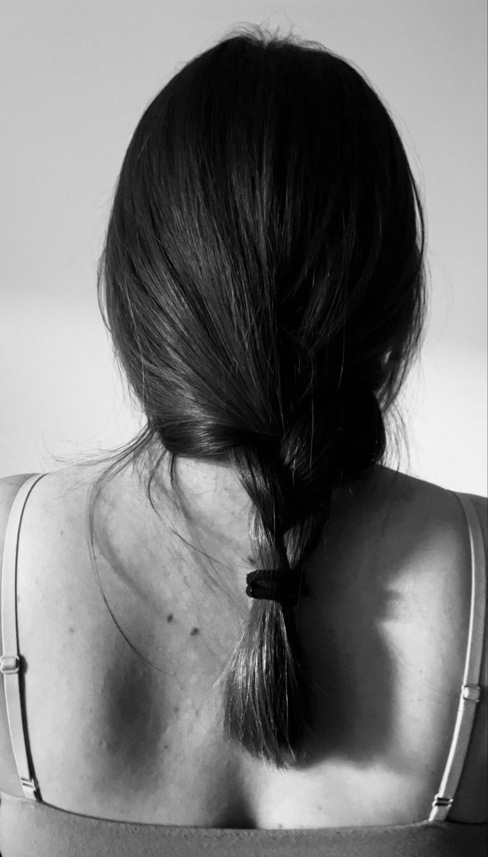 the back of a woman's head, with her hair in a pony tail