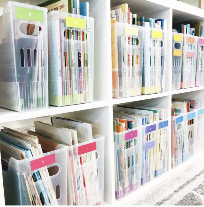 the shelves are filled with many different types of folders and file folders in plastic bins