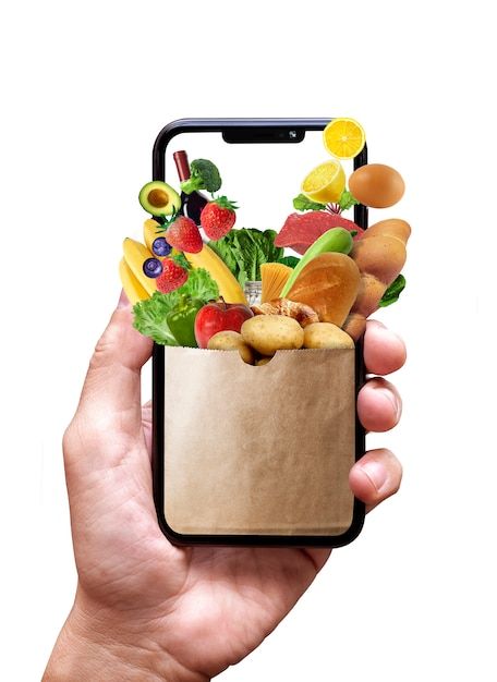 a hand holding a cell phone with a bag full of fruits and vegetables in it