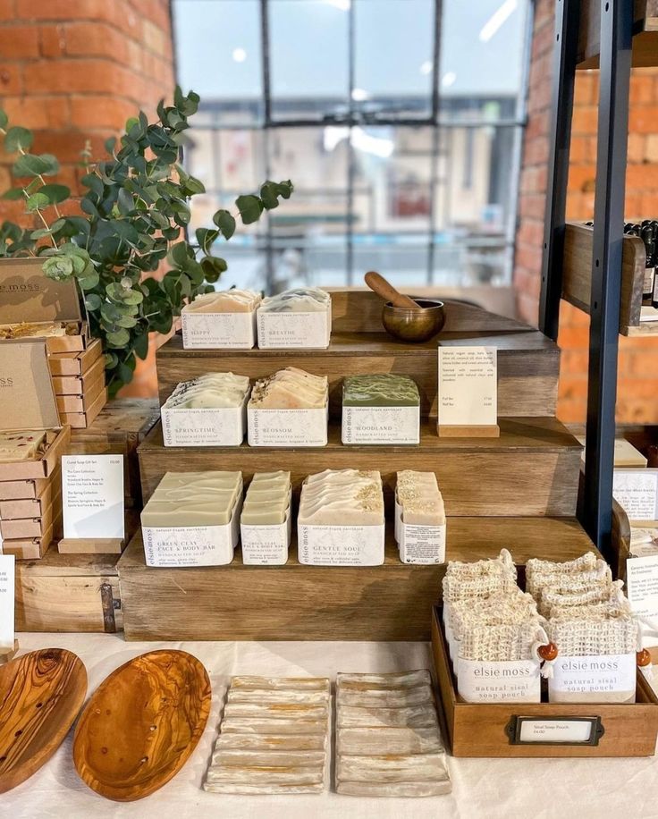 the table is set up with different types of soaps and wooden trays on it