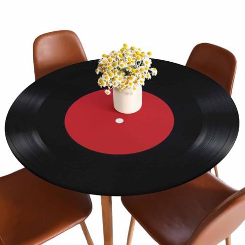 a vase with flowers is on top of a record table that has four chairs around it