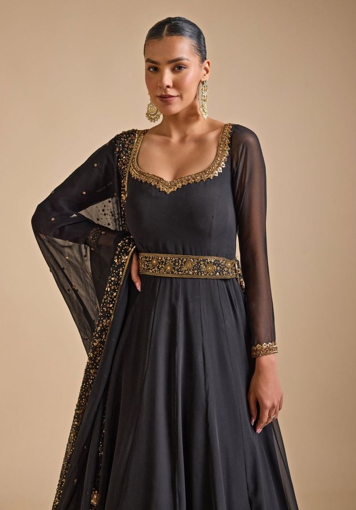 Elevate your festive wardrobe with Black Embroidered Anarkali Gown. Crafted from luxurious georgette, the lightweight anarkali features intricate sequin and zardozi floral embroidery, adding a touch of glamour. The double-layered detailing offers a sophisticated silhouette. Paired with a matching dupatta and embellished belt complete the ensemble. Ideal Anarkali Gown ensemble for Cocktail parties and Sangeet party. Composition : Georgette Care: Dry Clean Only and Vacuum Storage This product can Embroidered Anarkali, Embellished Belt, Vacuum Storage, Indian Wedding Wear, Anarkali Gown, Cocktail Parties, Wedding Wear, Anarkali, Floral Embroidery