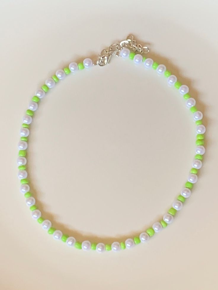 Cute, summery, fun, trendy, adjustable, lime green bead pearl choker. Length: 13.5-16 in. Custom sizes available. Handcrafted. Spring Beaded Choker Necklaces, Spring Beaded Adjustable Choker, Adjustable Green Choker Necklace, Trendy Green Beaded Necklace For Gift, Trendy Summer Beaded Pearl Necklace, Trendy Summer Round Beads Choker, Trendy Beaded Pearl Necklace For Summer, Trendy Summer Pearl Necklace With Colorful Beads, Casual Green Choker Jewelry