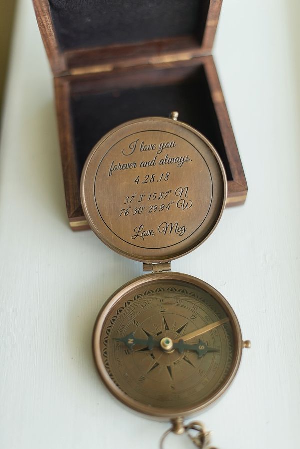 an old brass compass sitting on top of a white table