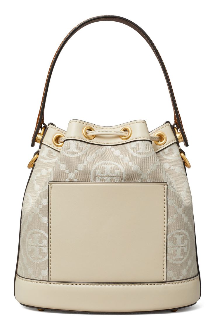 Logo-jacquard canvas and smooth leather provide textural interplay on this bucket bag featuring a drawstring closure cinched with a logo-embellished toggle. Structured silhouette with flat base and protective metal feet Lined Textile with leather trim Imported Luxury Beige Coated Canvas Bucket Bag, Bucket Shoulder Bag With Logo, Luxury Cream Bucket Bag For Travel, Luxury Bucket Shoulder Bag With Logo, Monogram Canvas Bucket Bag With Gold-tone Hardware, Cream Bucket Bag With Gold-tone Hardware For Travel, Chic Monogram Canvas Bucket Bag With Leather Handles, Travel Bucket Bag With Gold-tone Hardware And Coated Canvas, Travel Cream Bucket Bag With Gold-tone Hardware