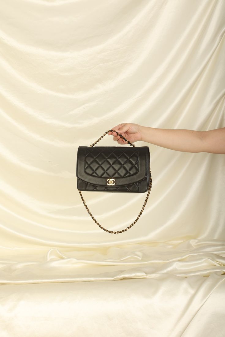 CONDITION: VERY GOOD VINTAGE .?ÿ Crafted from the finest lambskin leather, this medium Diana bag features a sleek and streamlined design with a stunning 24K gold plated chain and hardware. The black color is versatile and perfect for any occasion, while the signature Chanel diamond quilted pattern adds a touch of luxury and elegance. The spacious interior of this bag features multiple compartments, including a zip pocket, allowing you to keep all of your essentials organized and easily accessible. The adjustable chain strap can be as a single or double strap, giving you the flexibility to wear it as a shoulder bag or crossbody. Named after one of the most iconic woman in history, this bag truly carries on the history and elegance of Princess Diana. Crafted in 1991-1994 Strap drop: 20"?ÿ 10 Luxury Vintage Shoulder Bag With Chain Strap, Luxury Vintage Bags With Chain Strap, Luxury Black Shoulder Bag With Multiple Compartments, Luxury Leather Bag With Diamond Quilting, Luxury Vintage Bag With Chain Strap, Luxury Quilted Wallet On Chain For Women, Elegant Luxury Shoulder Bag With Single Strap, Luxury Black Shoulder Bag With Multiple Pockets, Luxury Leather Elegant Wallet On Chain