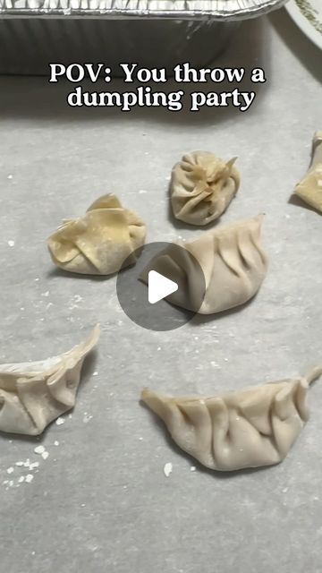 dumplings are being prepared on a baking sheet