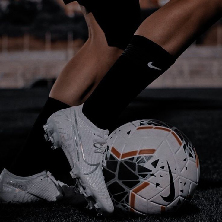 a soccer player with his foot on the ball