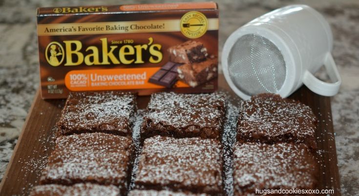 chocolate brownies and baker's powdered sugar sit on a cutting board