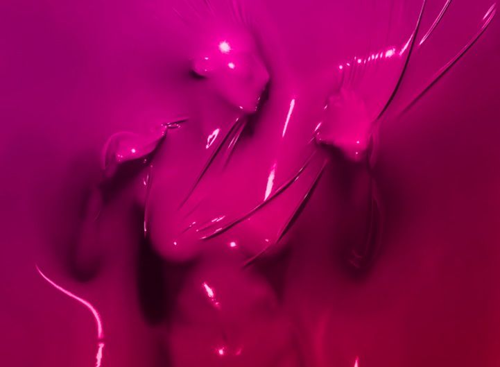 a woman covered in pink liquid with her hands on her hips and head tilted to the side