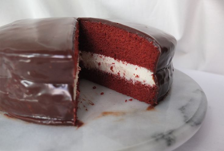 a red velvet cake with one slice cut out