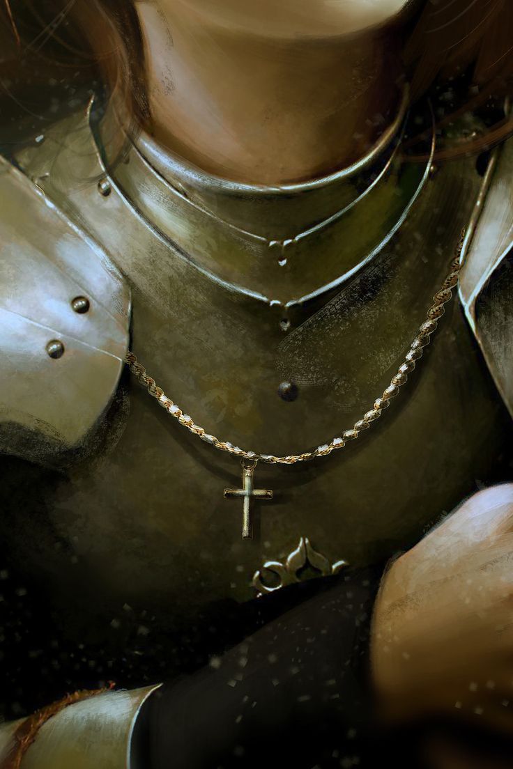 a close up of a person wearing a armor and holding a cross on their chest