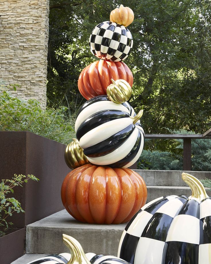 pumpkins are stacked on top of each other in the shape of checkered balls