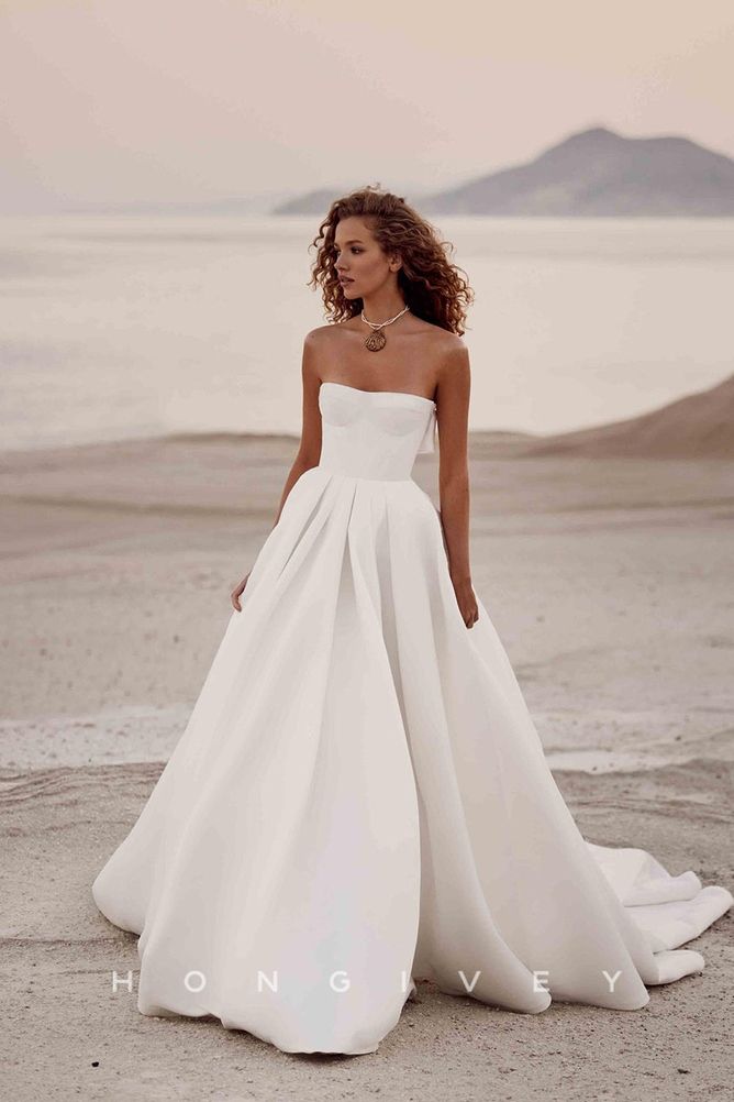 a woman in a white wedding dress standing on the beach