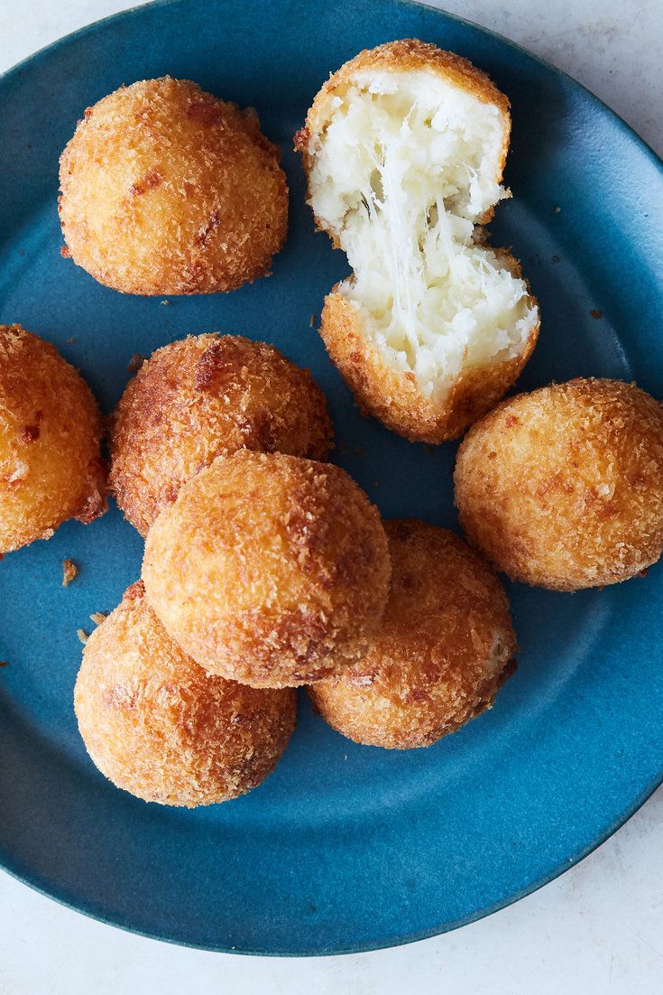 a blue plate topped with doughnut holes