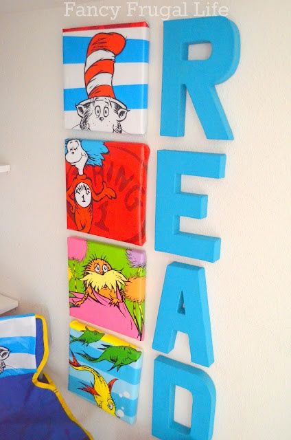 a child's bedroom with dr seuss and the cat in the hat wall art