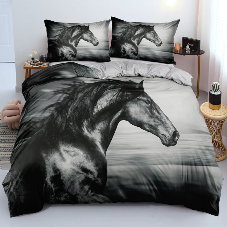 a black and white photo of a horse on a bed with two pillows in front of it