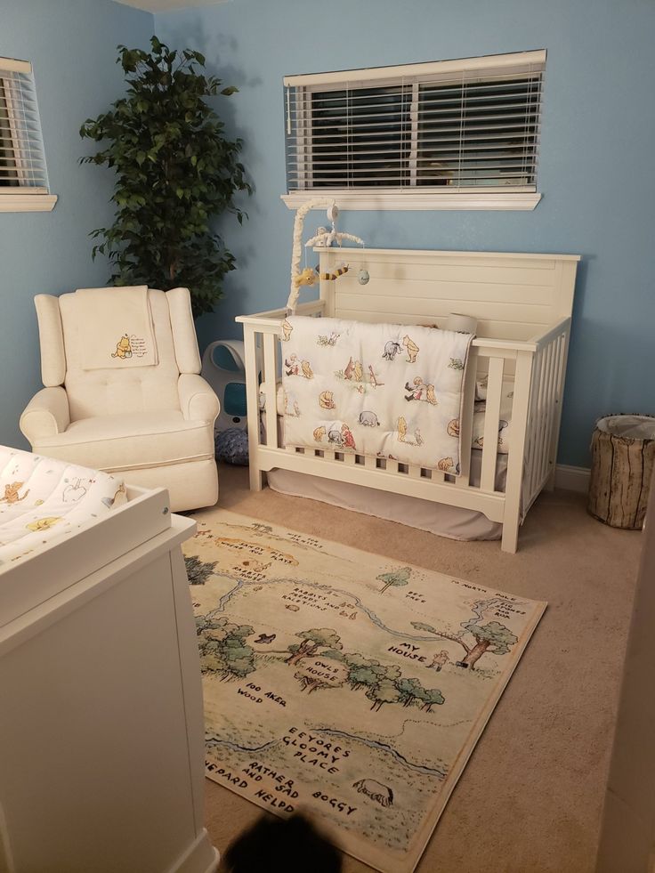 a baby's room with blue walls and furniture