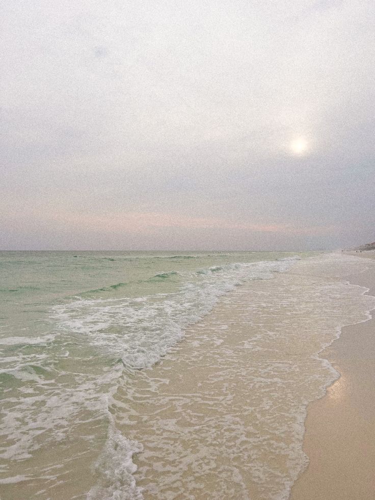 the beach has waves coming in to shore